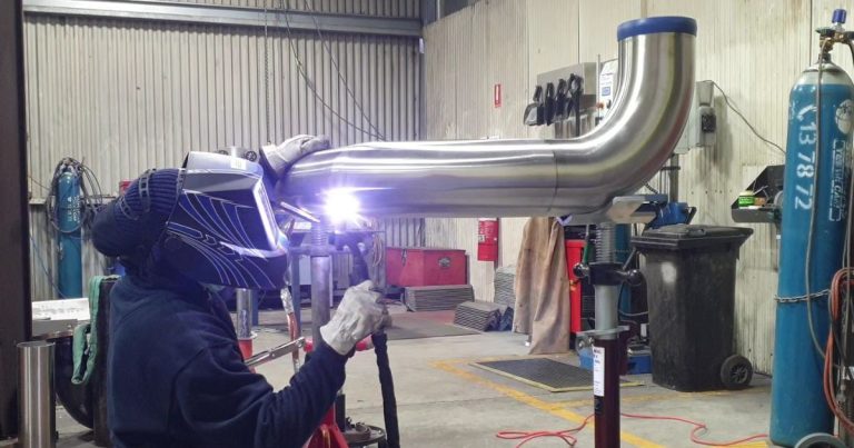 A topweld welder performing stainless steel pipeline system fabrication