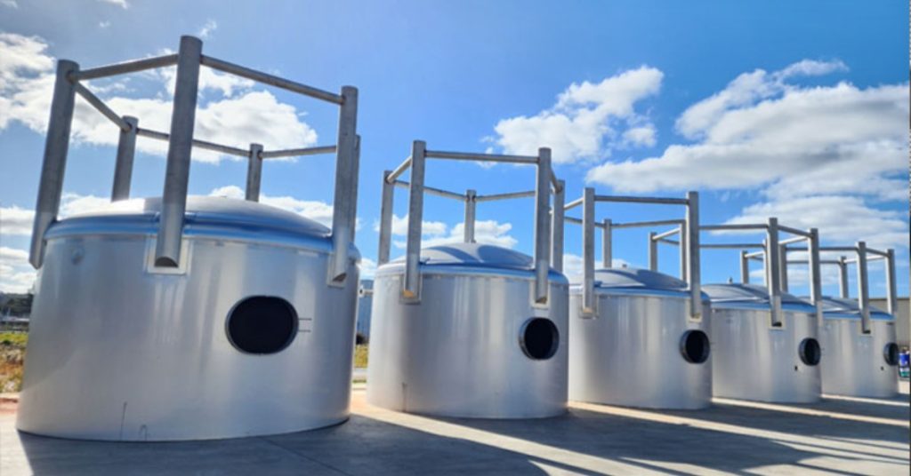 A custom-fabricated stainless steel tank to replace old tanks in a winery plant.