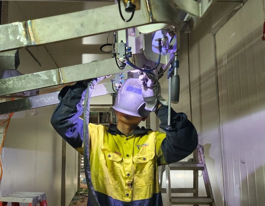 Topweld fabricator installing overhead rail system inside abattoir processing facility griffith, NSW